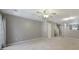A carpeted living room with neutral walls, and access to the staircase and other rooms at 10078 Pergola View Ct, Charlotte, NC 28213