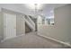 Spacious living room with views of the staircase, kitchen, and neutral paint colors at 10078 Pergola View Ct, Charlotte, NC 28213