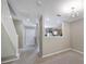 Bright living room with staircase, entry way, and an opening to the kitchen area at 10078 Pergola View Ct, Charlotte, NC 28213