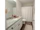 Modern bathroom featuring a granite countertop, white cabinets, and wood-style flooring at 103 Springway Dr, Kannapolis, NC 28081