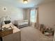 Bright Bedroom decorated with playful daisy decals and a white crib by the window at 103 Springway Dr, Kannapolis, NC 28081