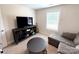 A cozy living room with a comfortable gray couch, entertainment center, and natural light at 103 Springway Dr, Kannapolis, NC 28081