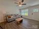 Comfortable living room featuring a plush sofa and natural light at 103 Springway Dr, Kannapolis, NC 28081