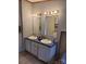 Bathroom with double sinks, vanity, lighting, and large mirrors at 111 Crystal Creek Dr, China Grove, NC 28023