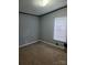Simple bedroom features neutral gray tones and a window for natural lighting at 111 Crystal Creek Dr, China Grove, NC 28023