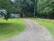 Gravel driveway leading to the home and white storage building at 111 Crystal Creek Dr, China Grove, NC 28023