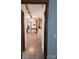 Hallway with wood flooring, and view of kitchen and living room at 111 Crystal Creek Dr, China Grove, NC 28023