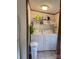 Functional laundry room with washer, dryer, overhead storage, and vinyl flooring at 111 Crystal Creek Dr, China Grove, NC 28023