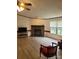 Bright living room features hardwood flooring, a ceiling fan, and a brick fireplace at 111 Crystal Creek Dr, China Grove, NC 28023