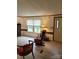Cozy living room featuring wood-look flooring, stone fireplace, and a comfortable rocking chair at 111 Crystal Creek Dr, China Grove, NC 28023
