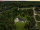 Scenic aerial view of the home surrounded by lush greenery and a serene neighborhood at twilight at 1115 Sides Rd, Salisbury, NC 28146