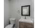 Half bathroom with wood vanity, modern fixtures, and toilet at 1115 Sides Rd, Salisbury, NC 28146