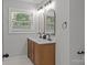 Bathroom featuring double sink vanity, lighting, and oval mirrors at 1115 Sides Rd, Salisbury, NC 28146