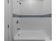 Bathroom features a new tub with white tile and a blue accent stripe at 1115 Sides Rd, Salisbury, NC 28146
