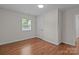 Bright bedroom features hardwood floors, a window, a closet, and neutral paint at 1115 Sides Rd, Salisbury, NC 28146