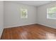Bright bedroom with hardwood floors and natural light from two windows at 1115 Sides Rd, Salisbury, NC 28146