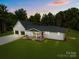 Charming home showcasing a manicured lawn, stone accents, and a three-car garage at 1115 Sides Rd, Salisbury, NC 28146