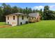 Inviting two-story home boasts a lush lawn and a charming wooden deck, blending comfort with outdoor beauty at 1115 Sides Rd, Salisbury, NC 28146