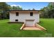 Home features a convenient drive-under garage, integrated seamlessly into a serene landscape with mature trees at 1115 Sides Rd, Salisbury, NC 28146