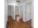 Hallway with hardwood flooring connecting multiple rooms and entryways at 1115 Sides Rd, Salisbury, NC 28146