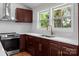 Modern kitchen features a stainless steel stove and hood, white countertops, and stylish copper fixtures at 1115 Sides Rd, Salisbury, NC 28146