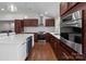 Modern kitchen features stainless steel appliances and an island with a white quartz countertop at 1115 Sides Rd, Salisbury, NC 28146