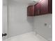A minimalist laundry room with upper cabinets and white tile floors at 1115 Sides Rd, Salisbury, NC 28146