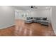Cozy living room with hardwood floors, a gray sectional sofa, and plenty of natural light at 1115 Sides Rd, Salisbury, NC 28146
