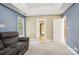 Bedroom features light carpet, gray sofa, windows and multiple doorways at 116 Scottie Ct, Rock Hill, SC 29730