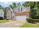 View of a two-story house with red brick, light-colored siding, a driveway, and an attached garage at 116 Scottie Ct, Rock Hill, SC 29730