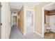 Hallway with neutral walls leads to a bedroom and bathroom with carpet flooring at 116 Scottie Ct, Rock Hill, SC 29730