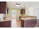 Functional kitchen with wooden cabinets, neutral countertops, tile flooring, and stainless steel appliances at 116 Scottie Ct, Rock Hill, SC 29730