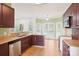 Large kitchen with wood cabinets, tile flooring, a breakfast bar, and natural light from multiple windows at 116 Scottie Ct, Rock Hill, SC 29730