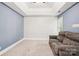 Living room features tray ceiling, sofa, light carpet and shiplap accent wall at 116 Scottie Ct, Rock Hill, SC 29730