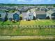Aerial view displays a fenced backyard, showcasing green lawns and neighborhood, close to a waterfront at 1207 Laggan Ln, Indian Trail, NC 28079