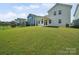 Backyard featuring a large lawn and a view of the home's exterior at 1207 Laggan Ln, Indian Trail, NC 28079