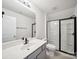 Modern bathroom with gray vanity, black fixtures and glass enclosed shower at 1207 Laggan Ln, Indian Trail, NC 28079