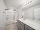 Bathroom featuring gray vanity, brushed nickel fixtures, and a tub with shower at 1207 Laggan Ln, Indian Trail, NC 28079
