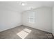 Bedroom featuring neutral carpet, a window with blinds, and overhead lighting at 1207 Laggan Ln, Indian Trail, NC 28079