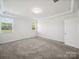Neutral bedroom featuring gray carpet, large window, tray ceiling, and bright interior at 1207 Laggan Ln, Indian Trail, NC 28079