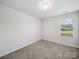 Bedroom featuring neutral carpet, a window with blinds, and overhead lighting at 1207 Laggan Ln, Indian Trail, NC 28079