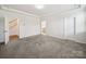Spacious bedroom with neutral walls and carpet, complemented by tray ceilings and ample natural light at 1207 Laggan Ln, Indian Trail, NC 28079