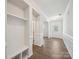 Inviting foyer featuring wainscoting, wood-look flooring, and a convenient built-in storage bench at 1207 Laggan Ln, Indian Trail, NC 28079