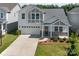 Beautiful exterior view of two-story home featuring an attached garage and manicured lawn at 1207 Laggan Ln, Indian Trail, NC 28079