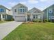 Charming two-story home with a well-manicured lawn, stone accents, and inviting front porch at 1207 Laggan Ln, Indian Trail, NC 28079