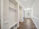 Bright entry hallway featuring luxury vinyl plank flooring, crisp white trim, and coat hooks at 1207 Laggan Ln, Indian Trail, NC 28079