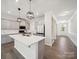 Open-concept kitchen showcasing gray cabinets, stainless appliances, large island, and seamless flow to dining area at 1207 Laggan Ln, Indian Trail, NC 28079