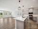 Open concept kitchen with stainless appliances, gray cabinets, and luxury vinyl plank flooring at 1207 Laggan Ln, Indian Trail, NC 28079