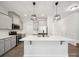 Modern kitchen featuring stainless steel appliances, gray cabinets, and a large island with a white countertop at 1207 Laggan Ln, Indian Trail, NC 28079