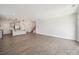 Expansive living room flowing into the kitchen, featuring wood floors, neutral walls, and lots of natural light at 1207 Laggan Ln, Indian Trail, NC 28079